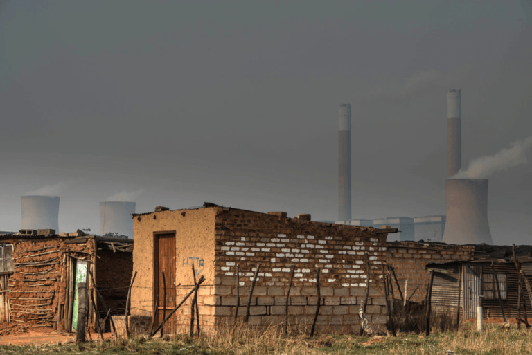 1720516938177_A-house-in-front-of-the-coal-fired-Duvha-Power-Station-on-the-outskirts-of-Witbank-Mpumalanga